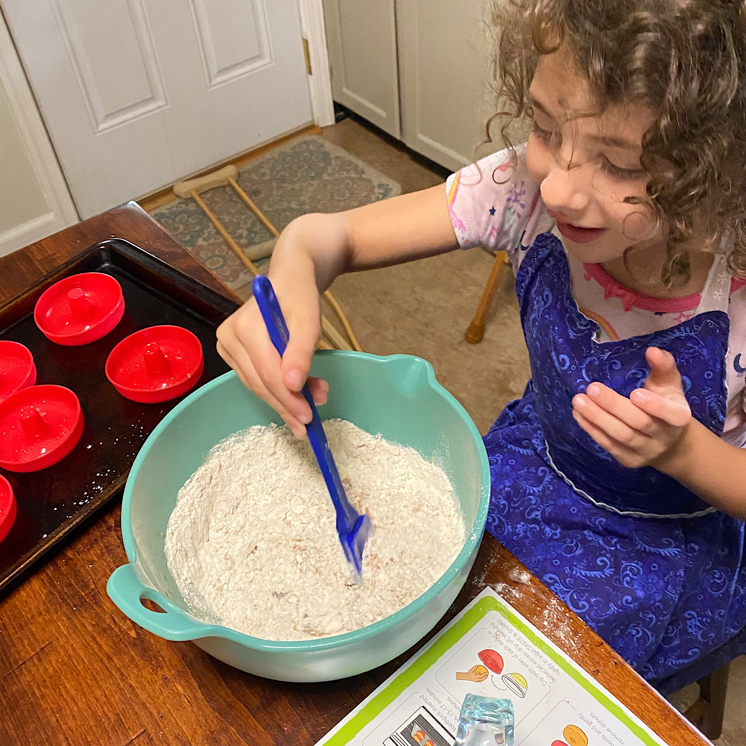 Brandi's daughter following the recipe instructions provided by Raddish Kids.