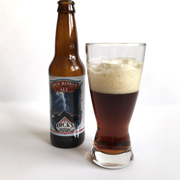 A bottle of Dick Danger Ale from Craft Beer Club next to a poured sample.