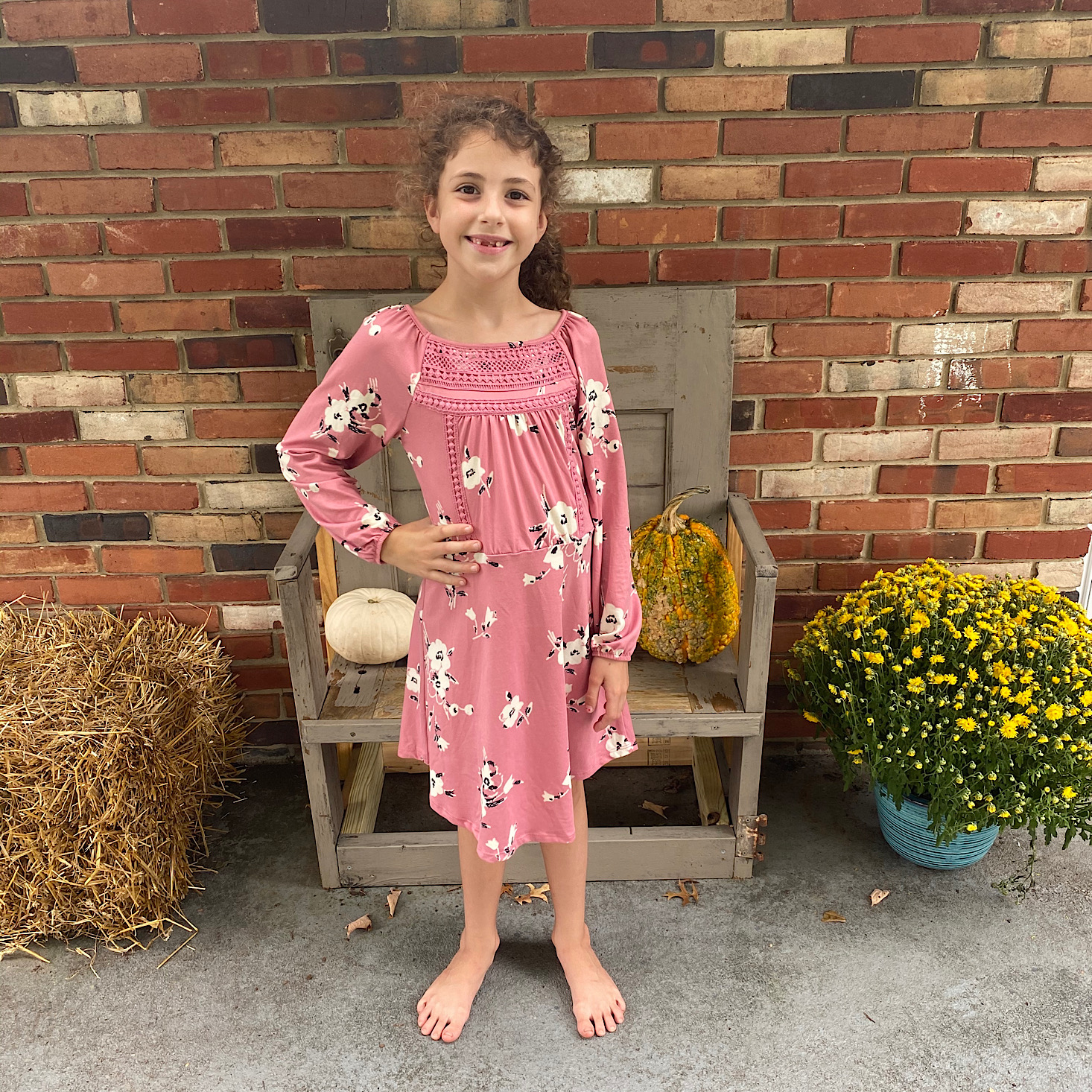 Brandi's daughter sporting her pink long-sleeve floral dress from Stitch Fix.
